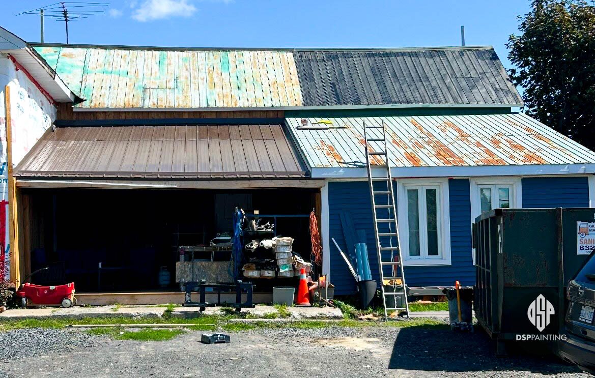 The roof partway through the job, rust and old green paint still showing across the metal panels